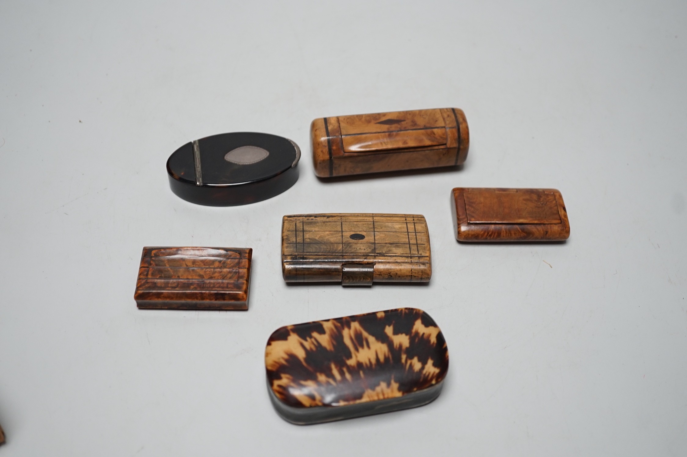 Two 19th century tortoiseshell snuff boxes and four treen snuff boxes.